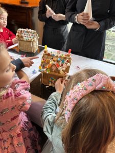 Children decorating gingerbread houses at the O.Henry Hotel's Nutcracker Tea.