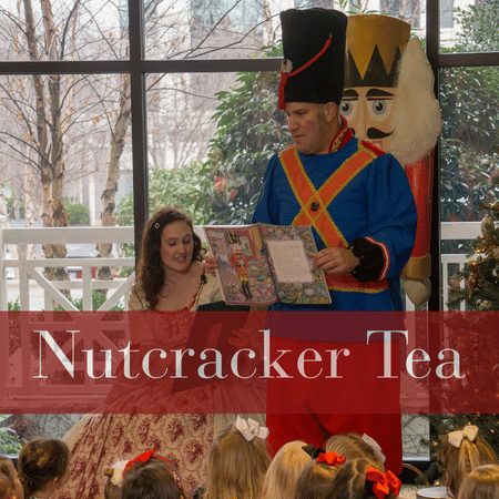 Nutcracker holding the story of The Nutcracker as Clara reads it to a crowd of children.
